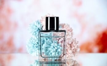 front view perfume bottle flowers beige blurred background 140725 145261